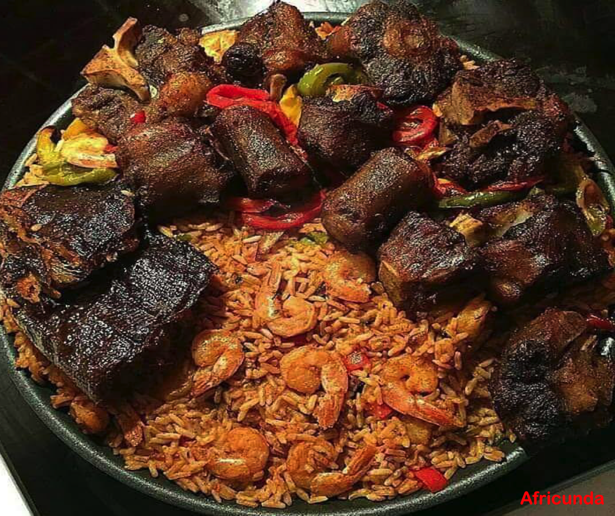 Traditional Jollof Rice with assorted grilled meat (Bushmeat, Cowtail, etc.)